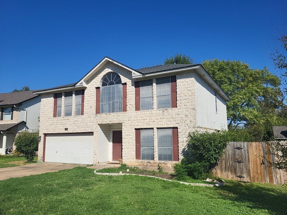 A large house with a lot of windows and a fence in front of it