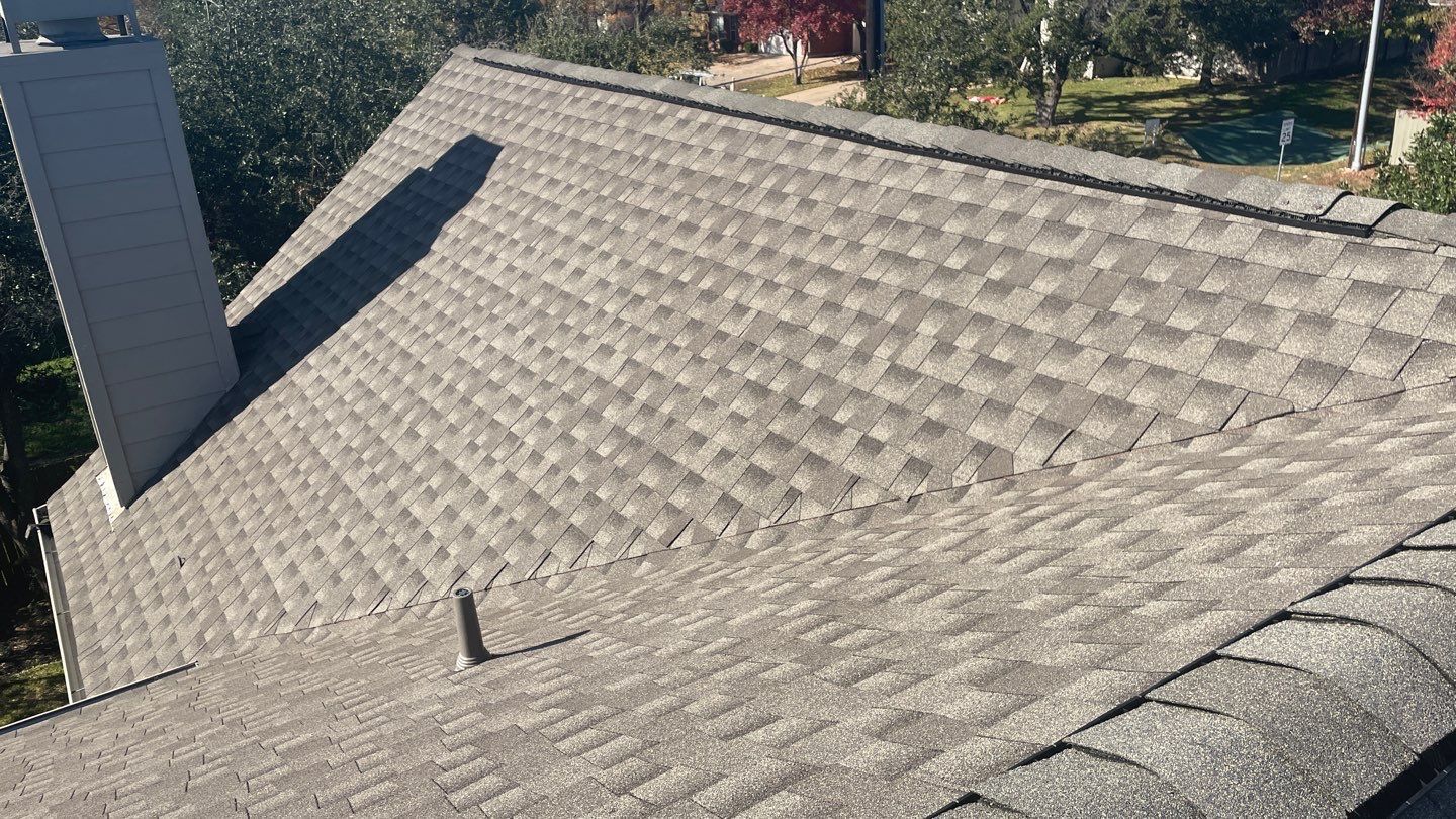 A close up of a roof with a chimney on top of it.