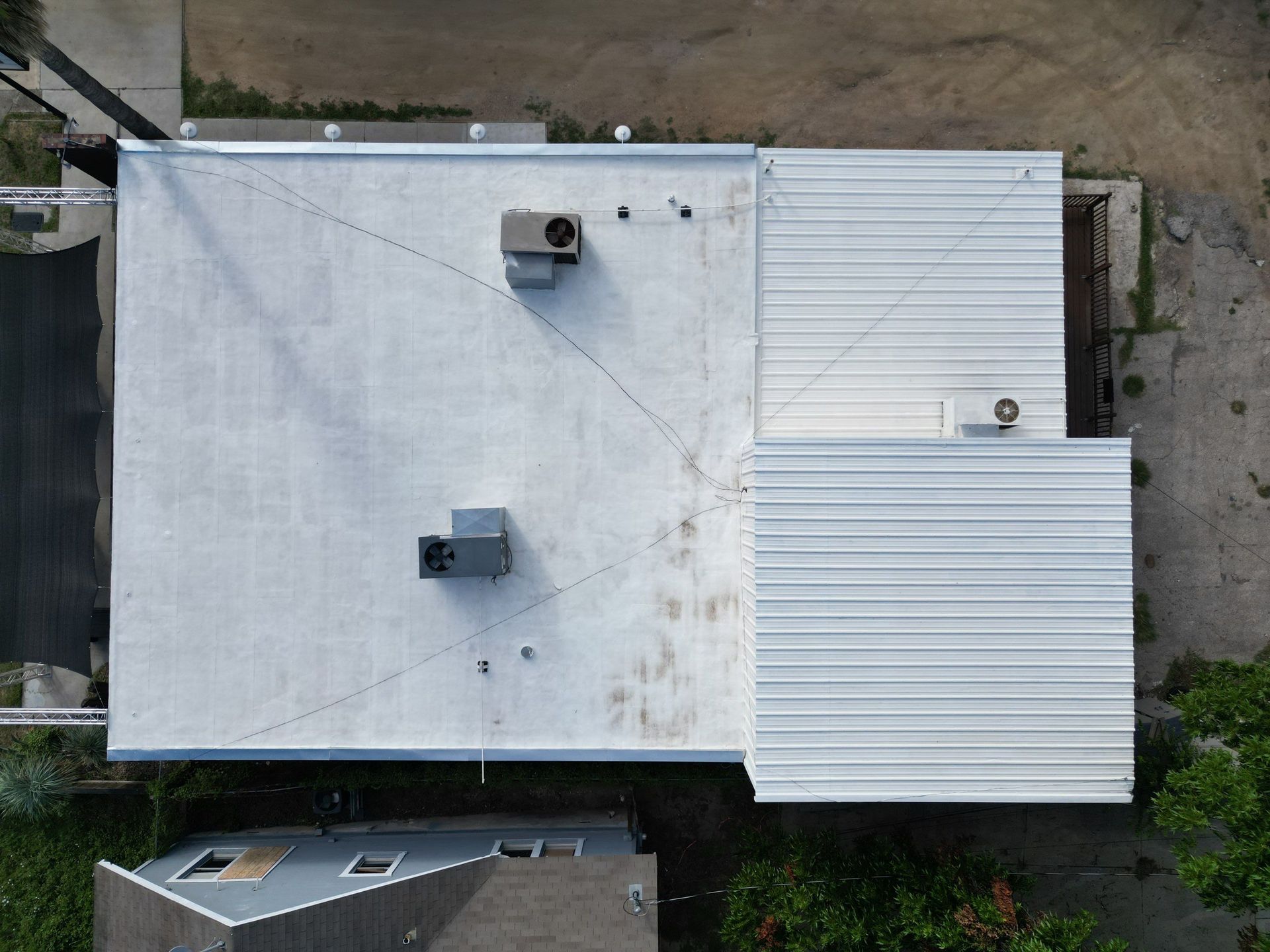 An aerial view of a white roof of a building.