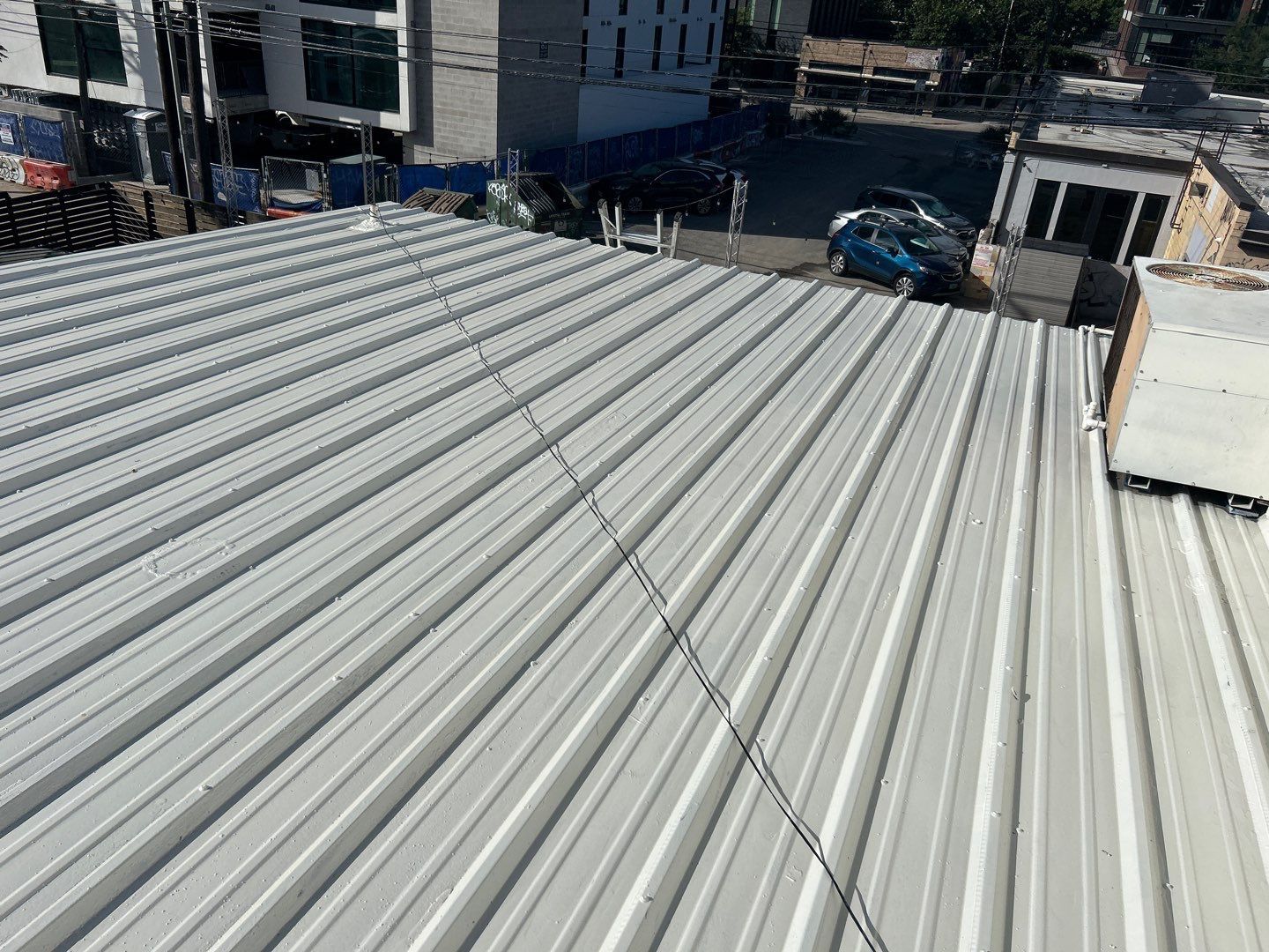 A white metal roof with a lot of lines on it.
