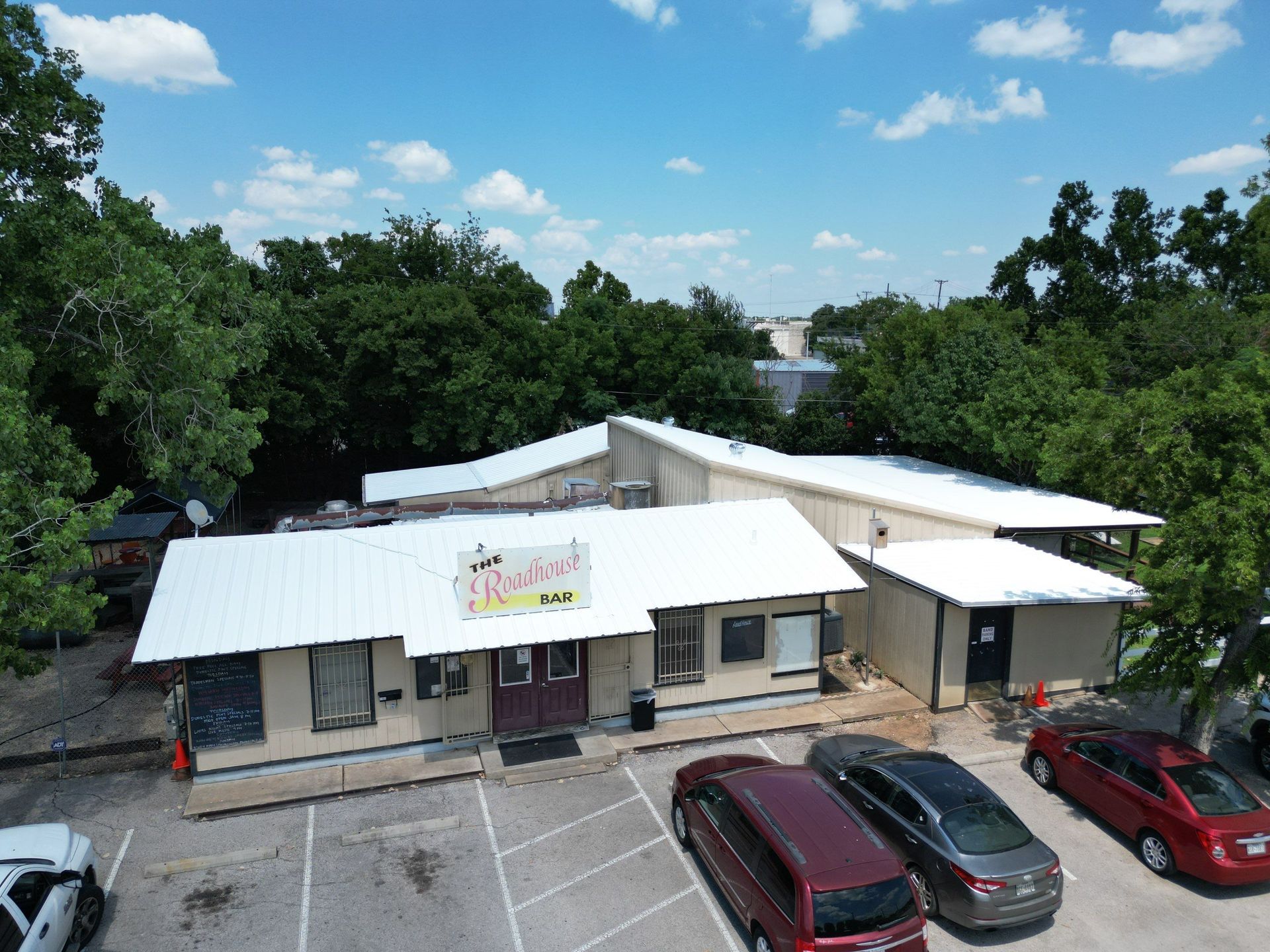 An aerial view of a building with cars parked in front of it