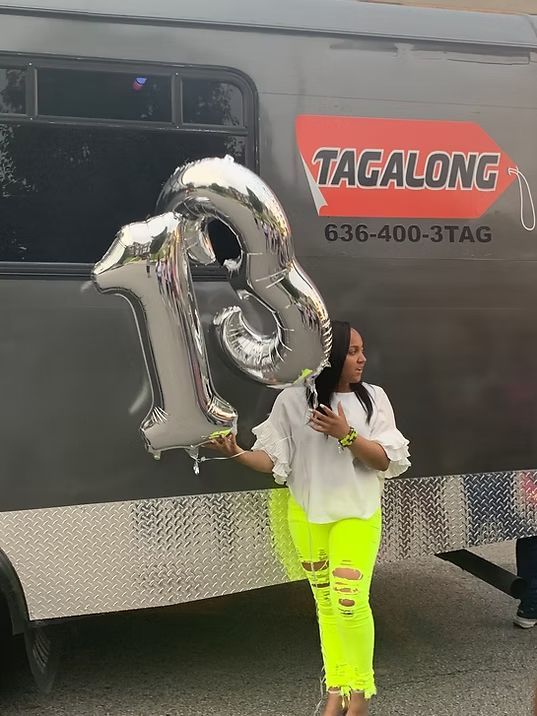 Woman in white top and neon yellow pants holds 