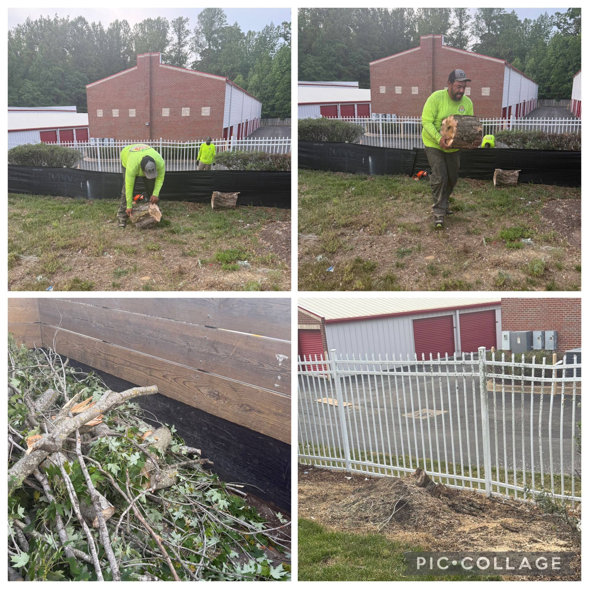 Worker in neon yellow cleaning debris and trimming brush beside a brick building and white fence