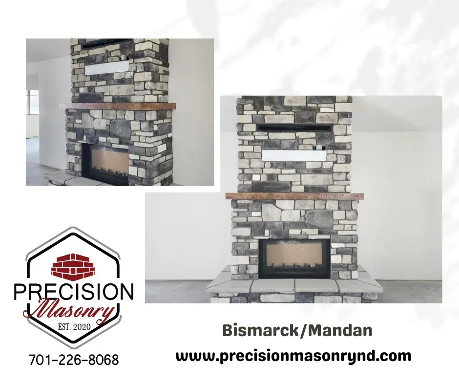 Stone fireplace with wooden mantel, by Precision Masonry. Location: Bismarck/Mandan. Website and phone number provided.