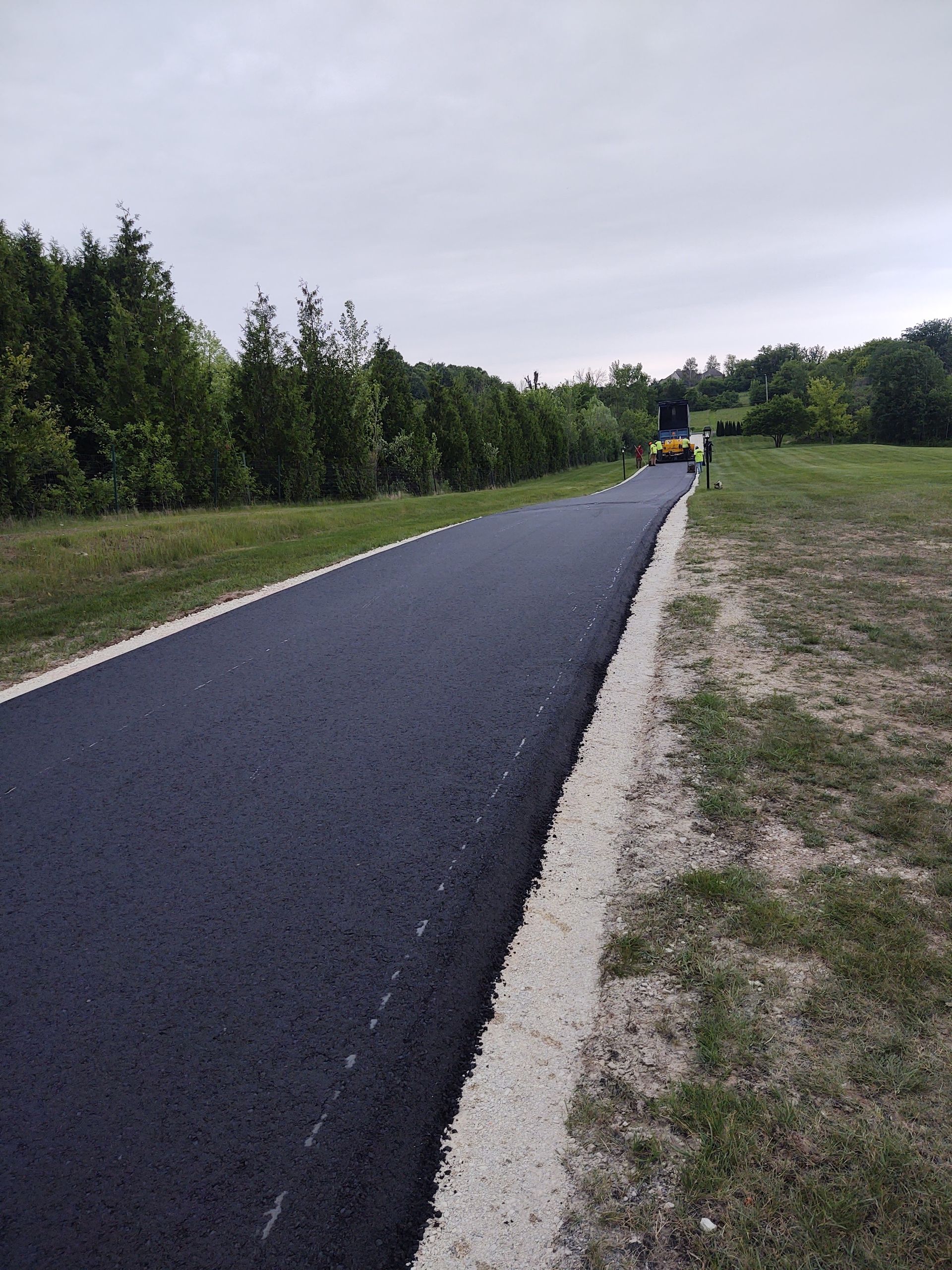 A person is riding a skateboard down a road.