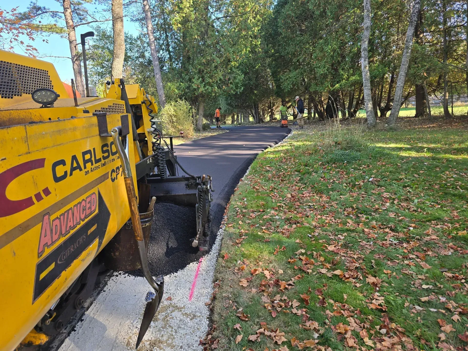A Carlso asphalt paving machine is working on a road.