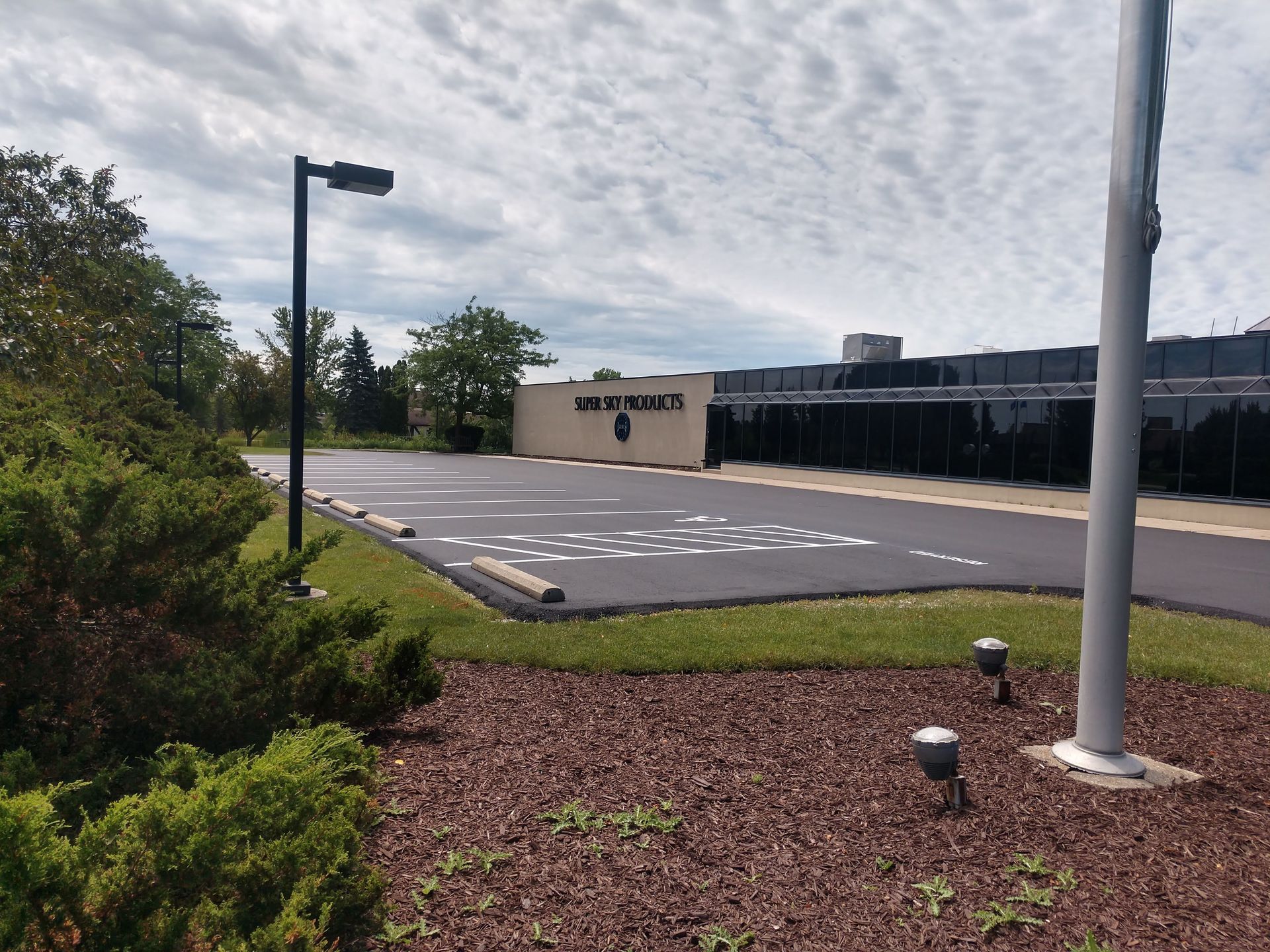 A parking lot with a building in the background that says web bros.