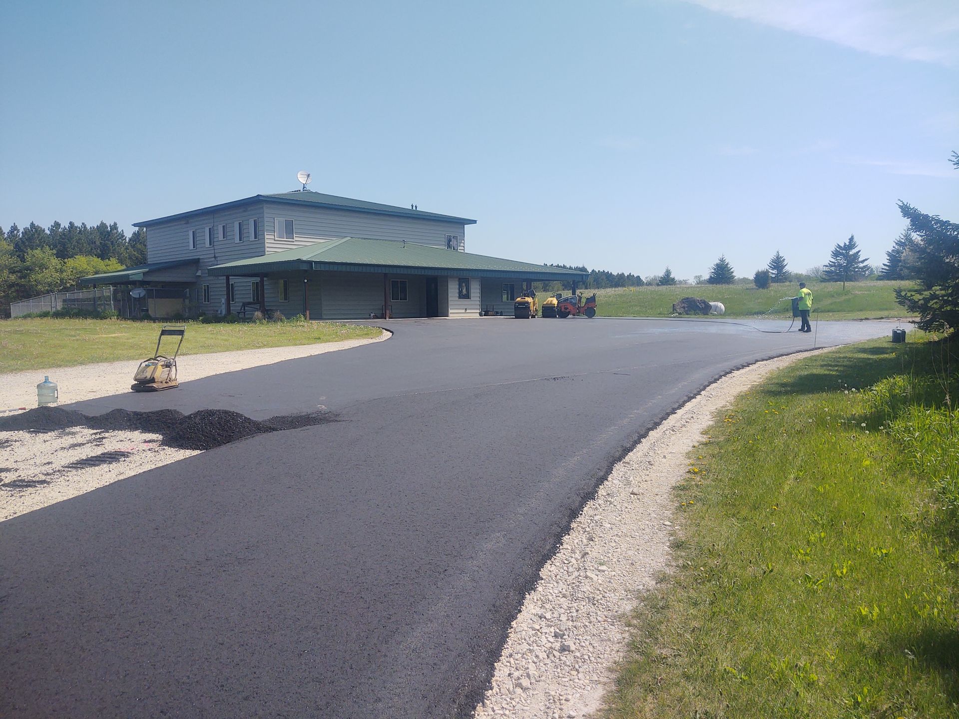 A road is being paved in front of a house.