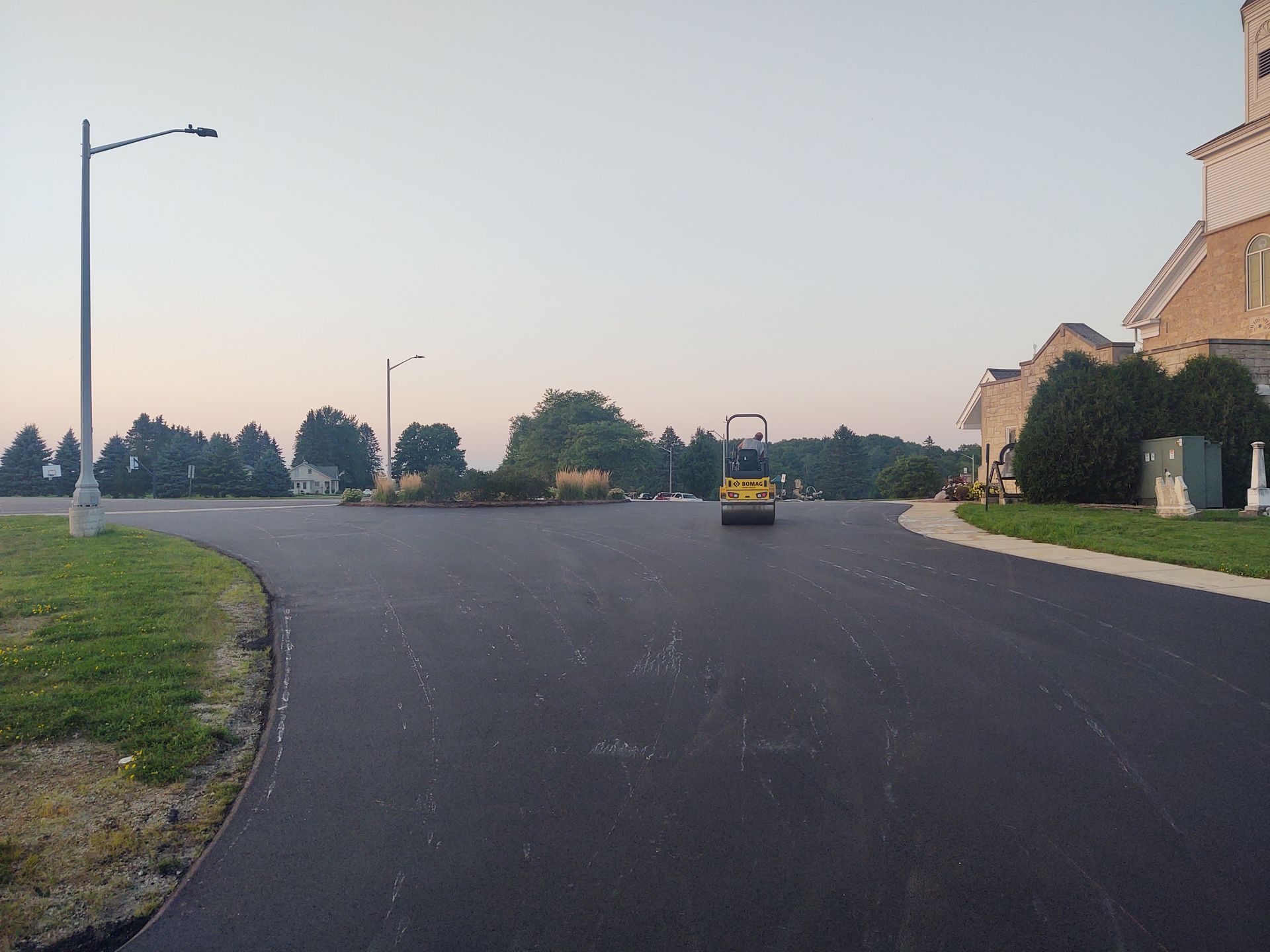 A yellow truck is driving down a residential street.