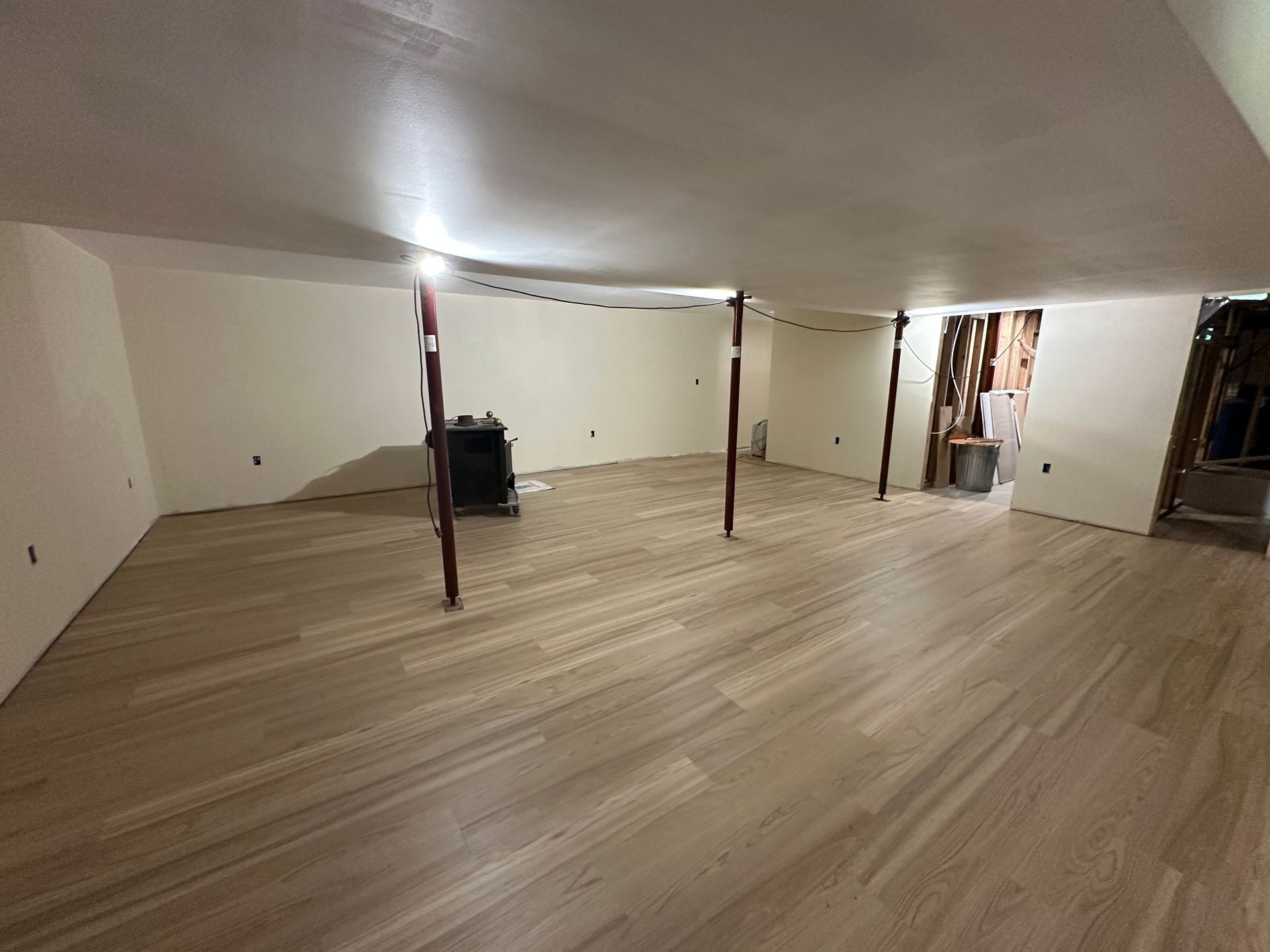 A room with a wooden floor and a white wall.