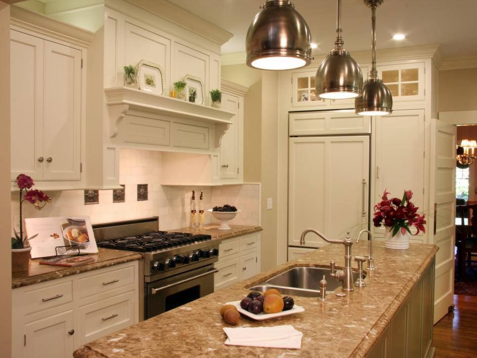 Cream-colored kitchen with granite countertops, stainless steel appliances, and pendant lights.