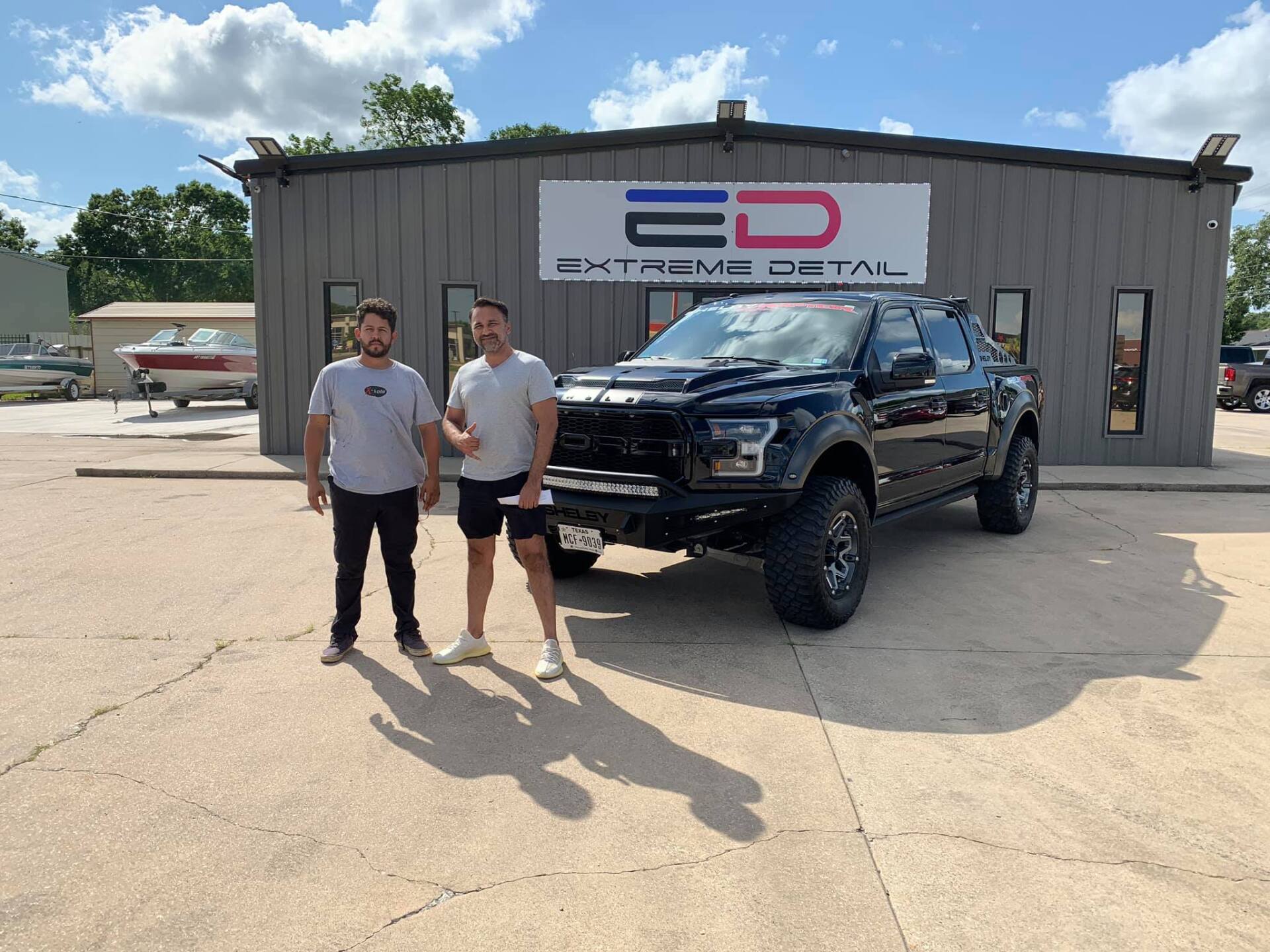 2 people standing in front of a truck