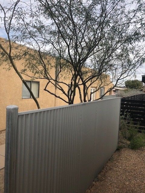 a fence with a tree in the background