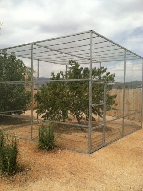 a fenced in area with a tree in the middle