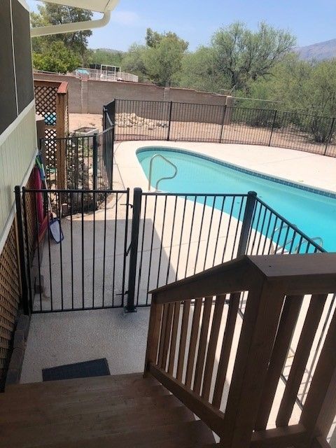 stairs leading up to a pool with a fence around it