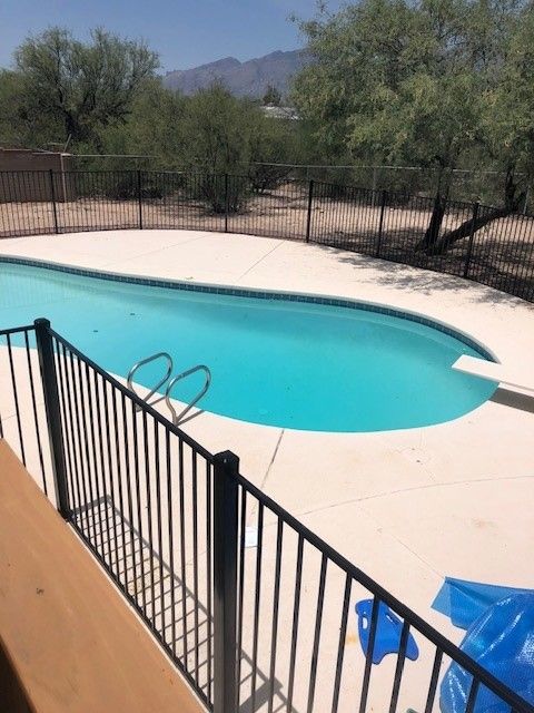 a large swimming pool with a fence around it