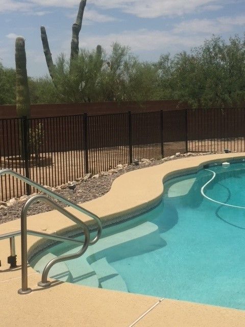 a large swimming pool with a fence around it