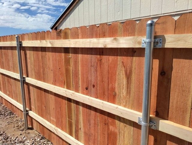 a wooden fence is being built in front of a house