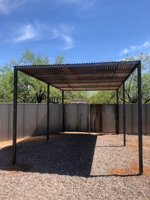 a fenced in area with a metal structure in the middle