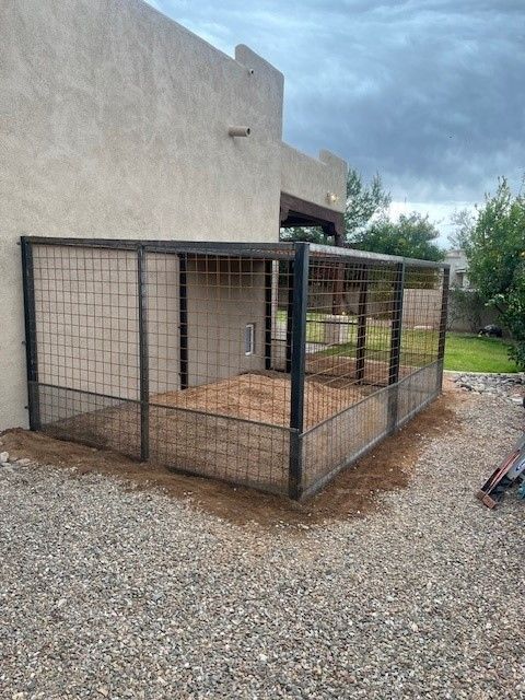 a dog kennel is sitting in the backyard of a house