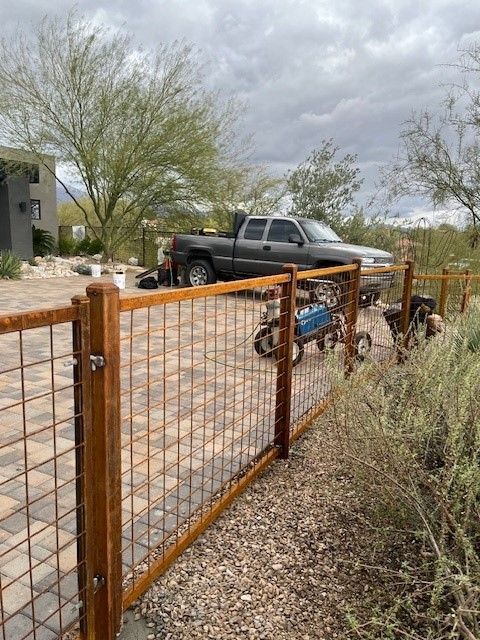 a truck is parked behind a wooden fence