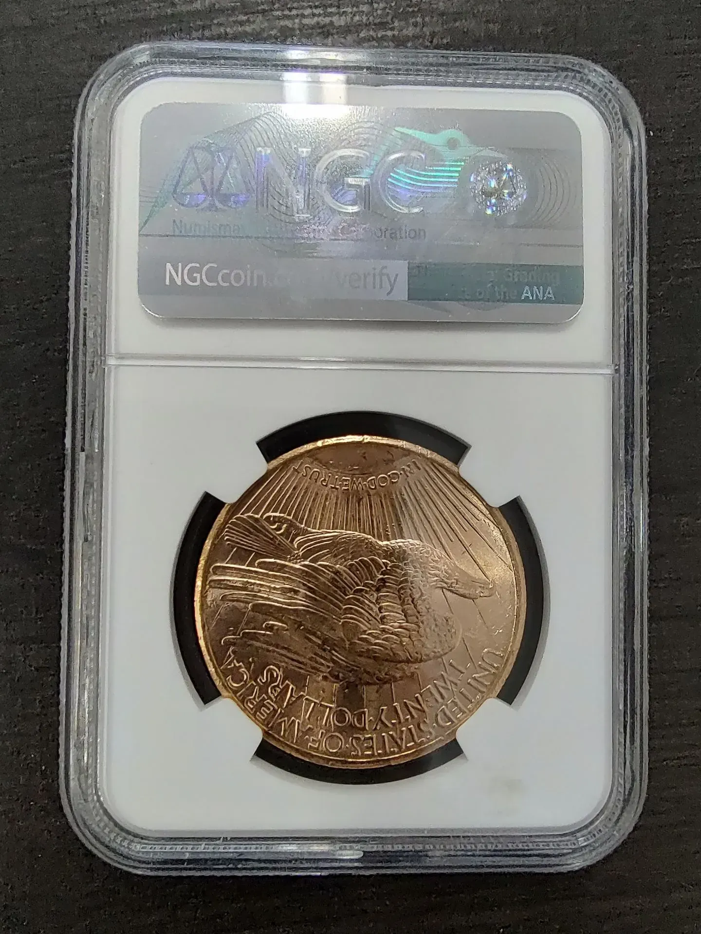Gold coin in a protective NGC holder.