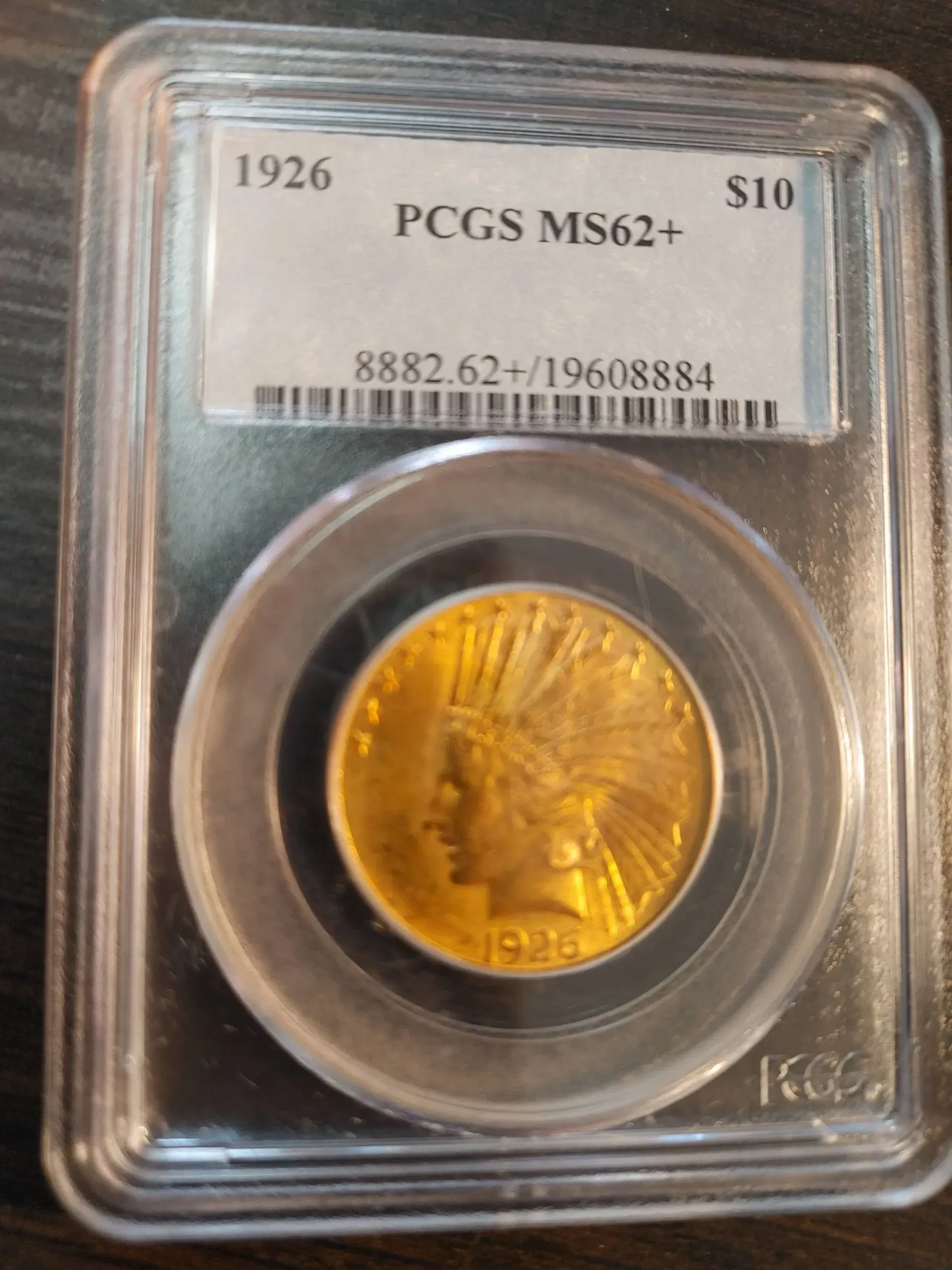 Gold coin inside a plastic PCGS holder, dated 1926.  Features an Indian head profile.