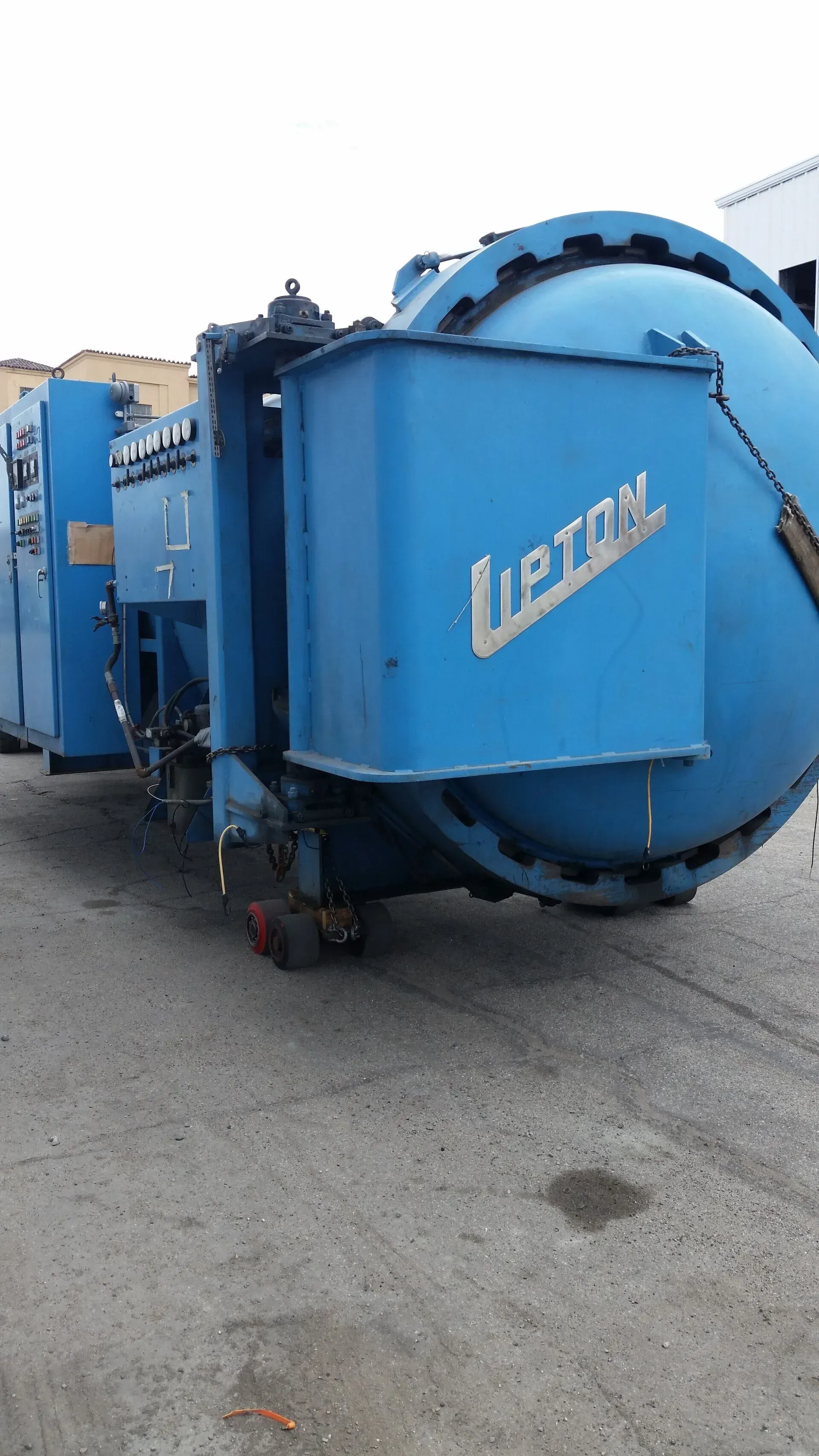 A large blue machine is parked on the side of the road.