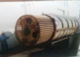 A large wooden barrel is sitting on top of a train track.