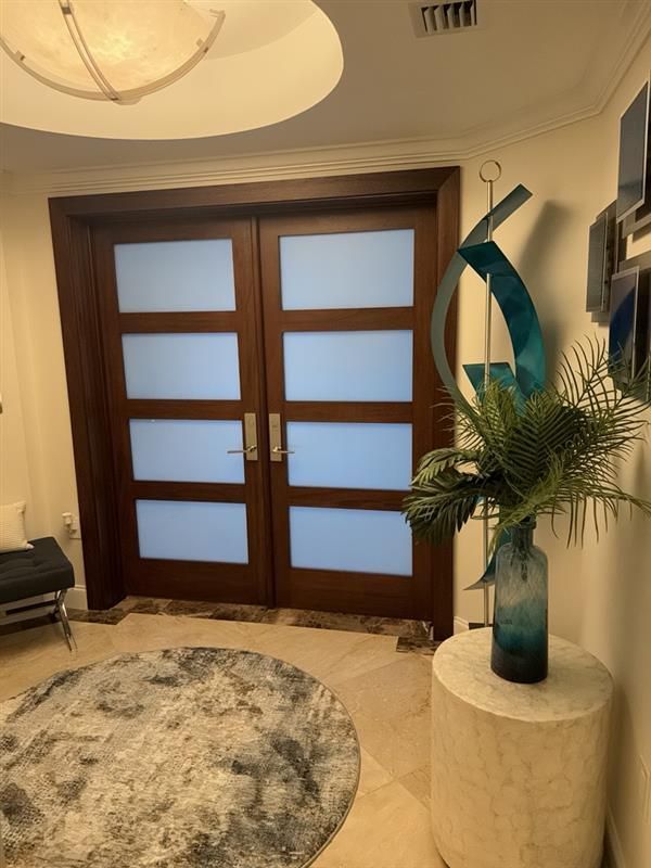 Two people installing a window outdoors. One in red shirt working on the frame. The other holding a window pane.