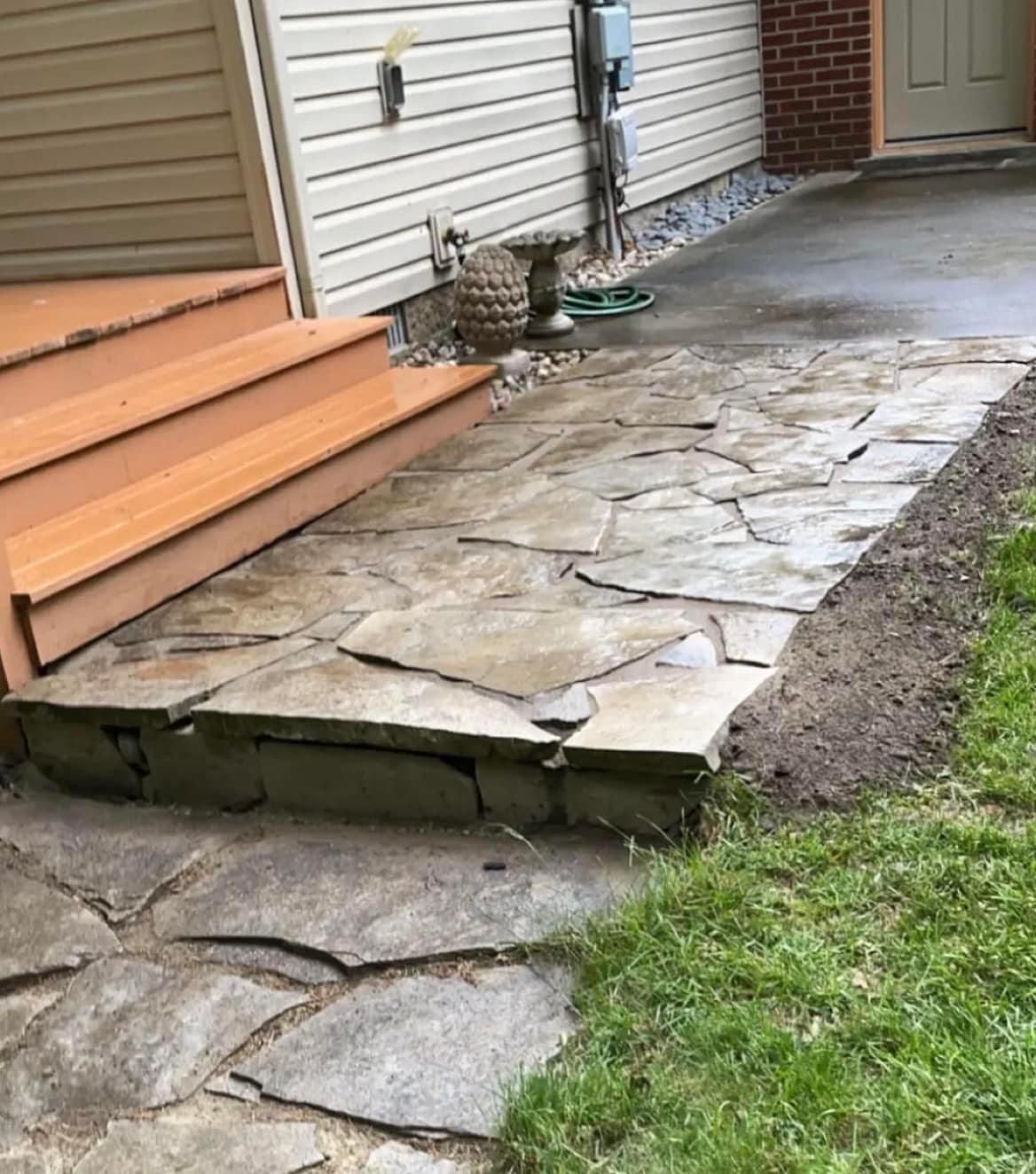 A stone walkway leading to the front door of a house.