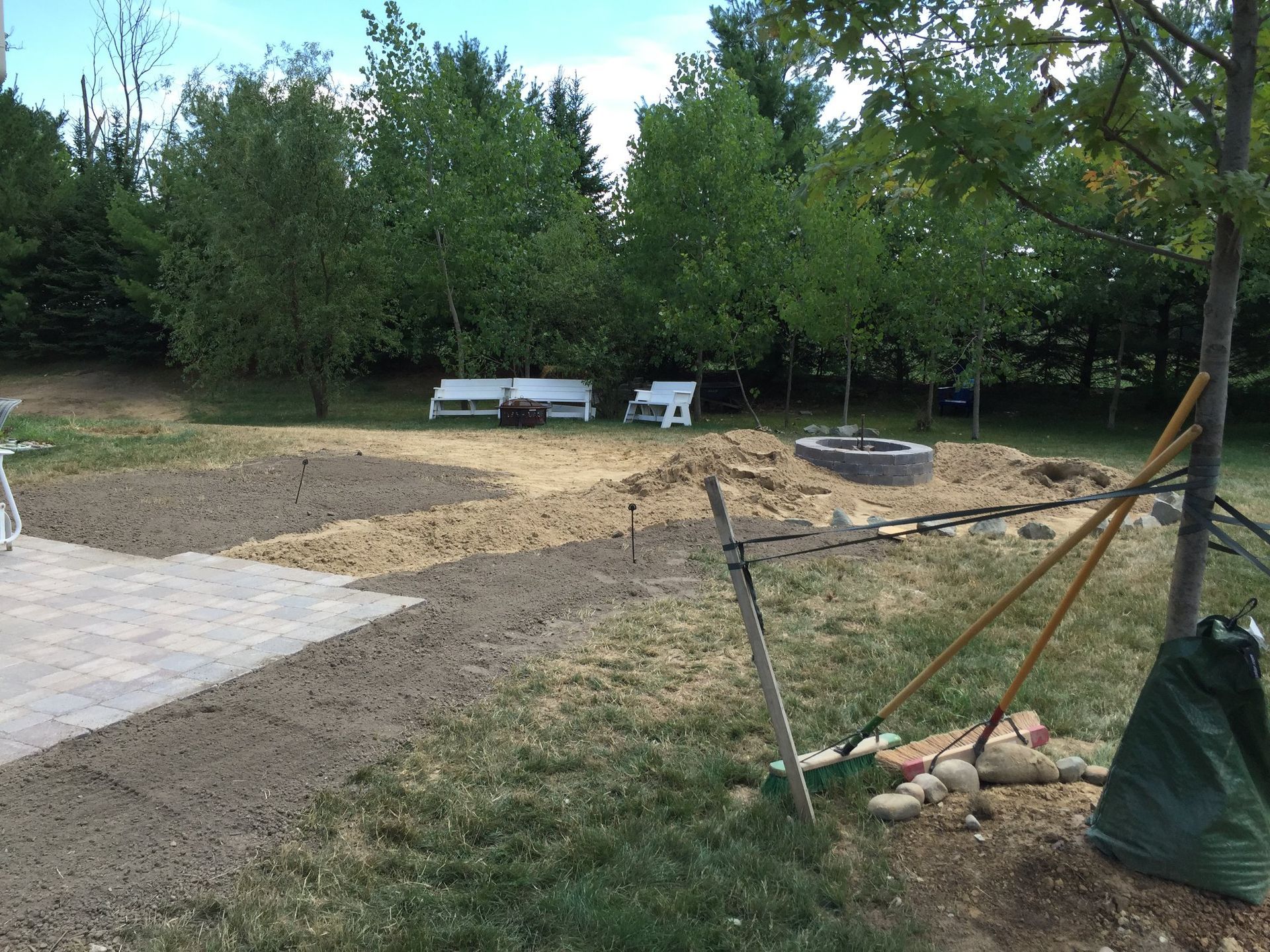 There is a fire pit in the middle of the yard.