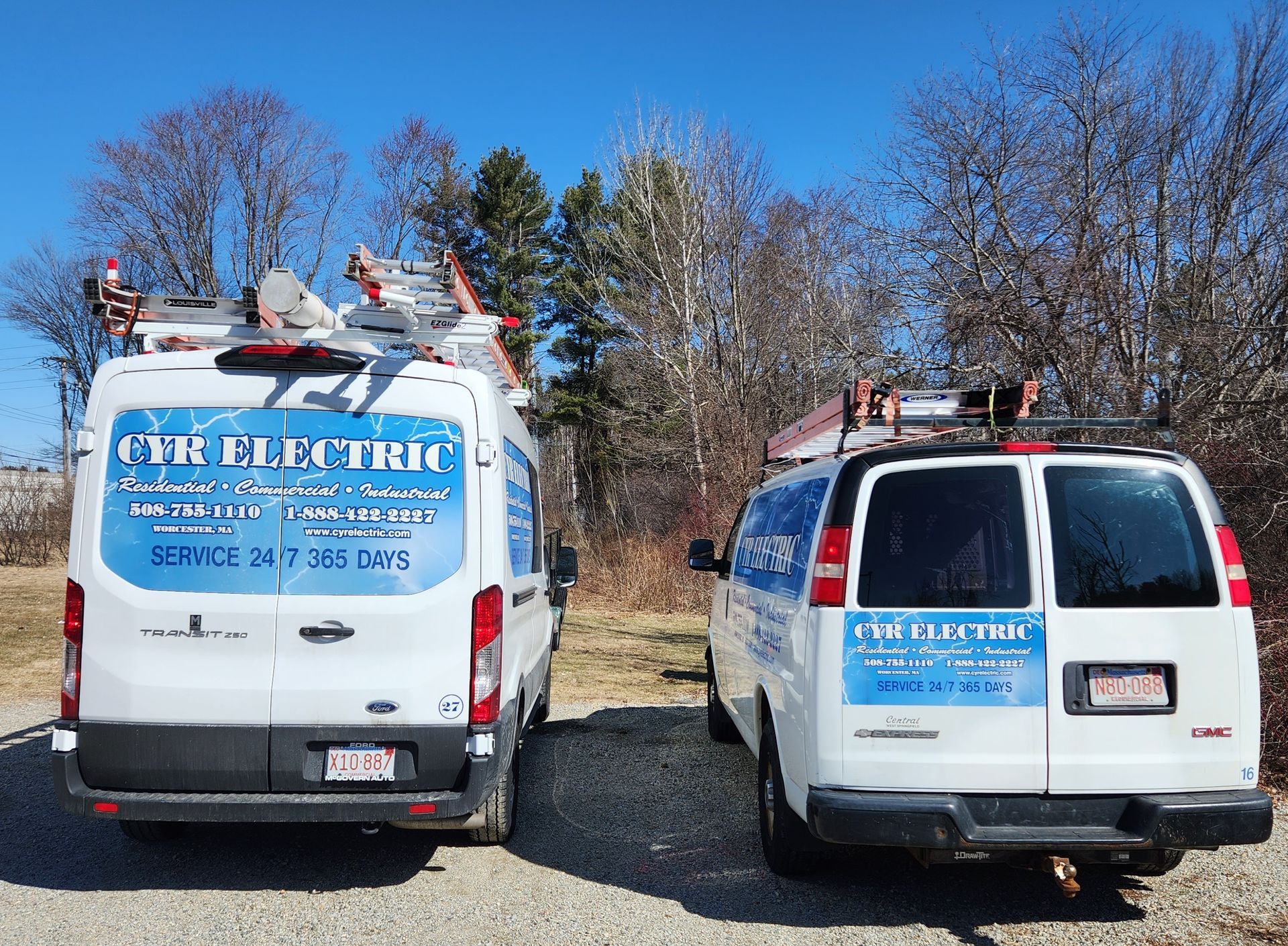 Two electric vans are parked next to each other