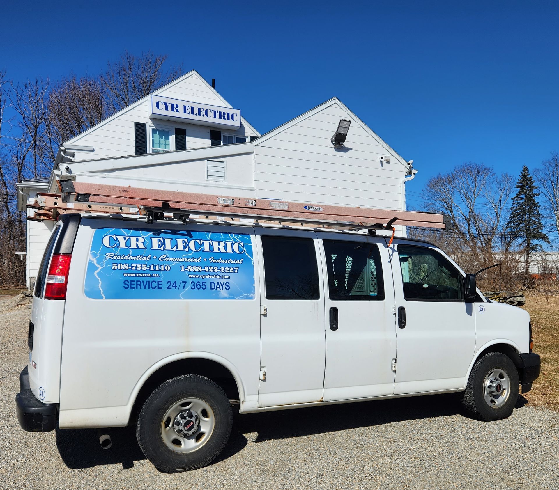 A white van is parked in front of a building that says utility electrical