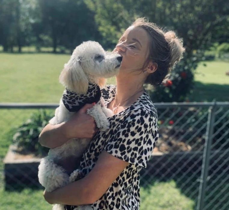 Woman carrying a dog