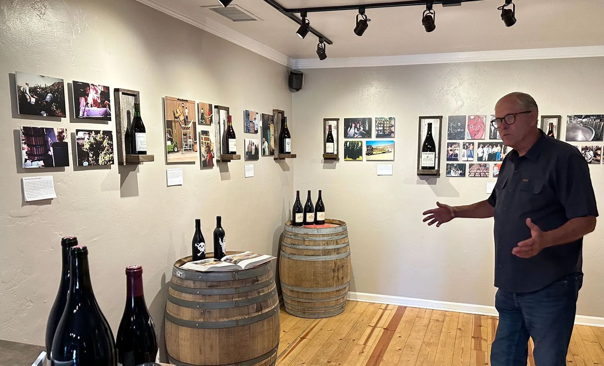 a room with barrels and bottles of wine