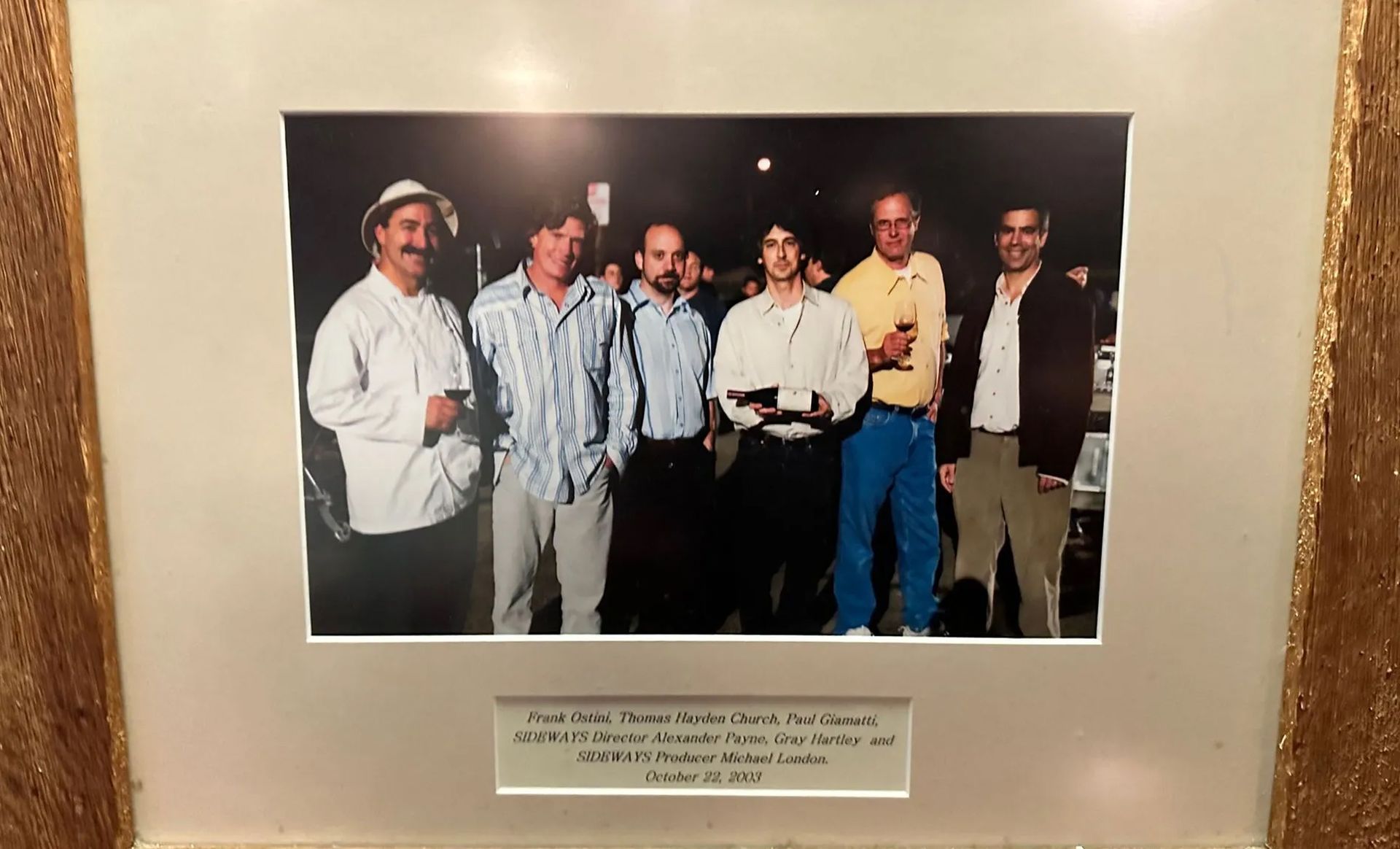 A framed photo of a group of men standing next to each other