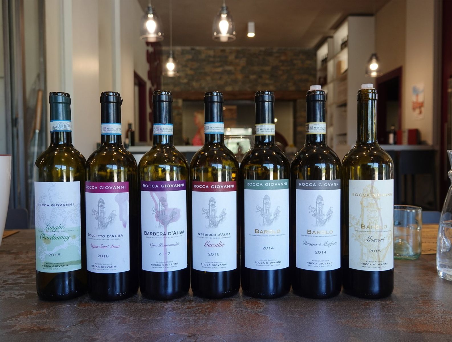 Several bottles of wine are lined up on a table