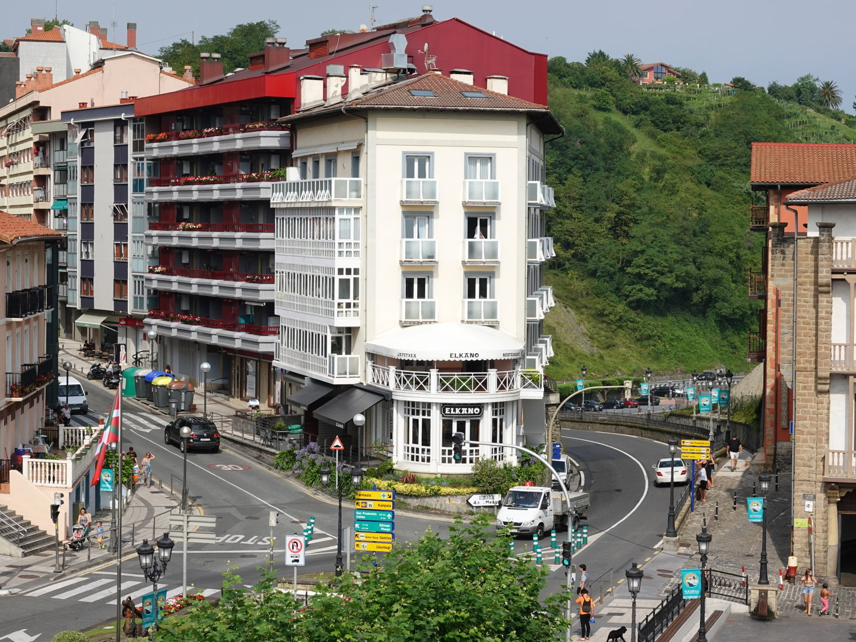 An aerial view of a city with a white building in the middle