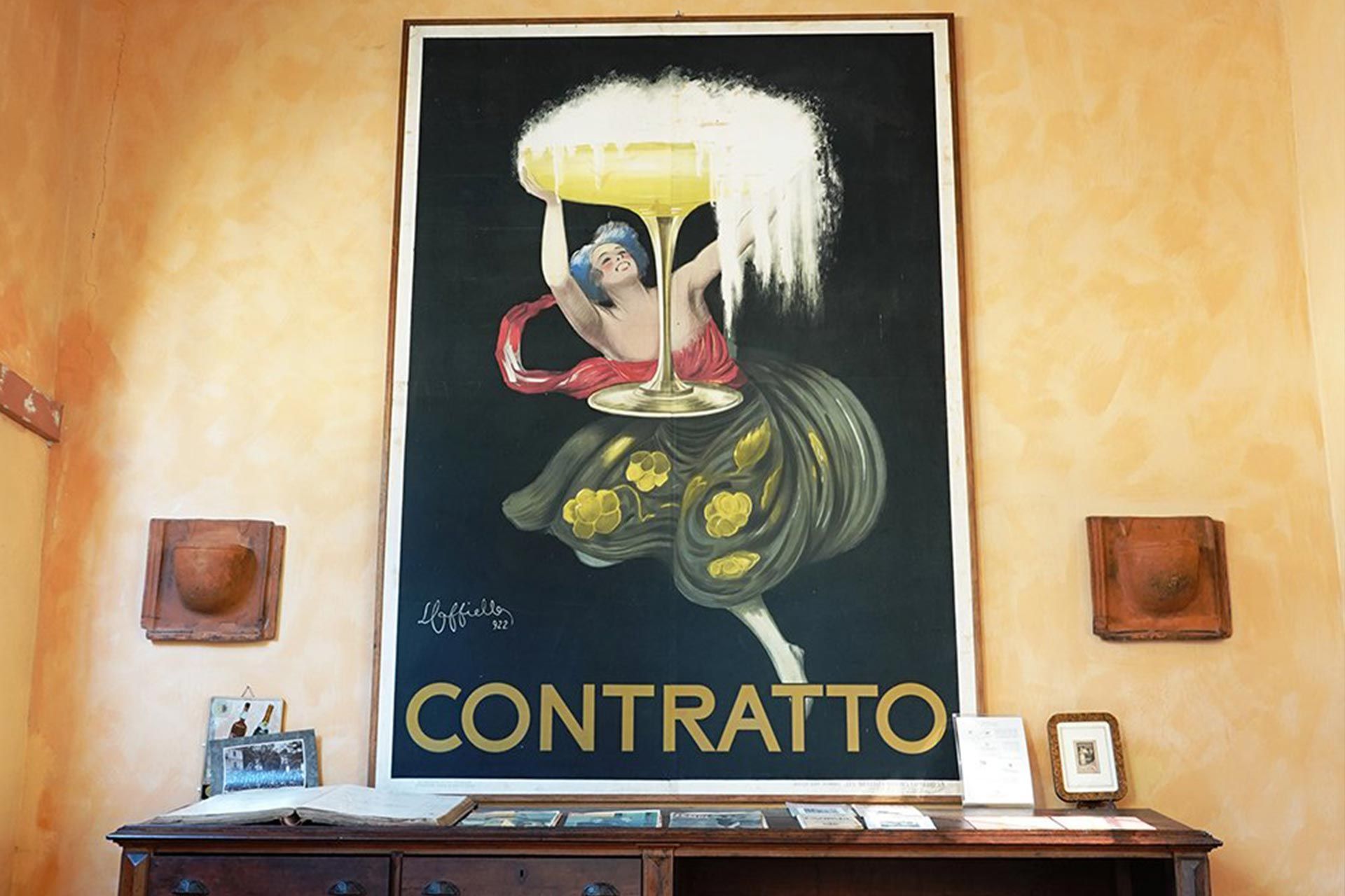 A large painting of a woman holding a glass