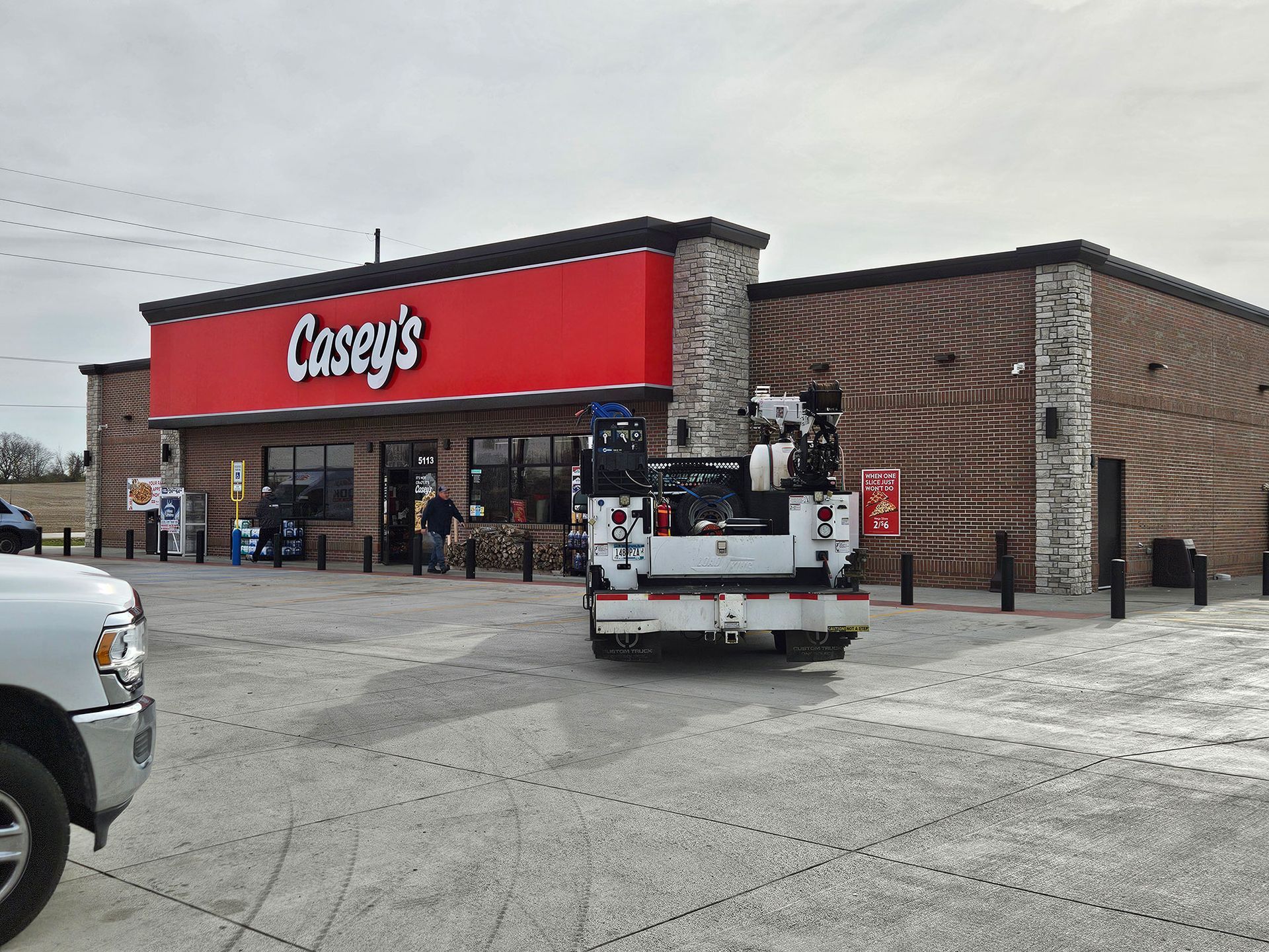 Casey's gas station with a service truck in the parking lot; red sign, brick facade.