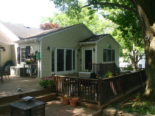 A house with a large deck in front of it