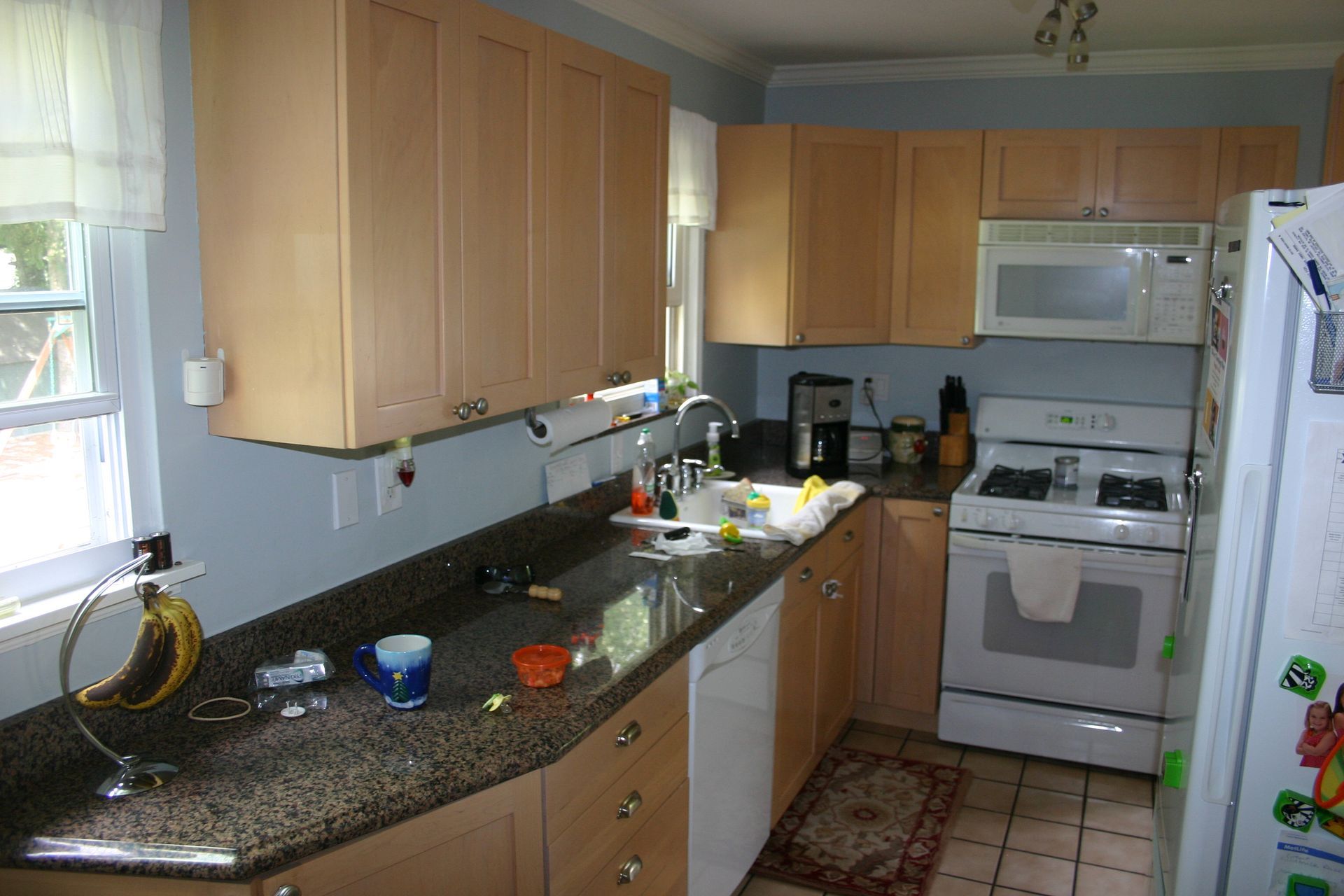 A kitchen with wooden cabinets and granite counter tops