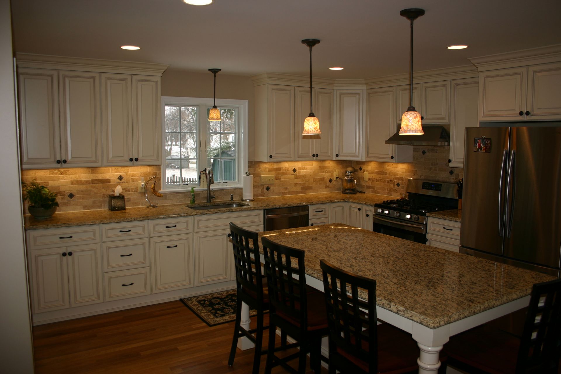 A kitchen with white cabinets and granite counter tops