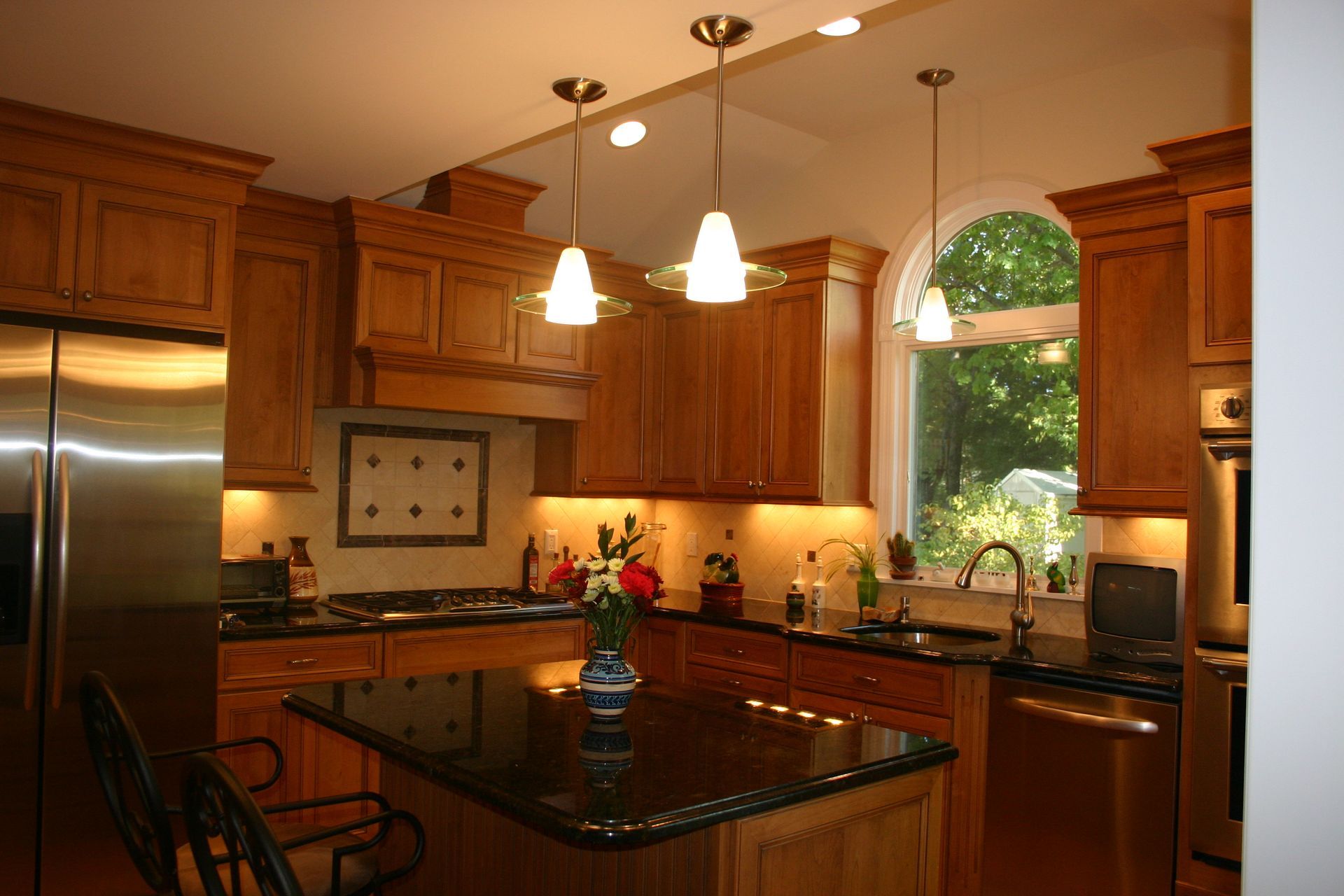 A kitchen with stainless steel appliances and wooden cabinets