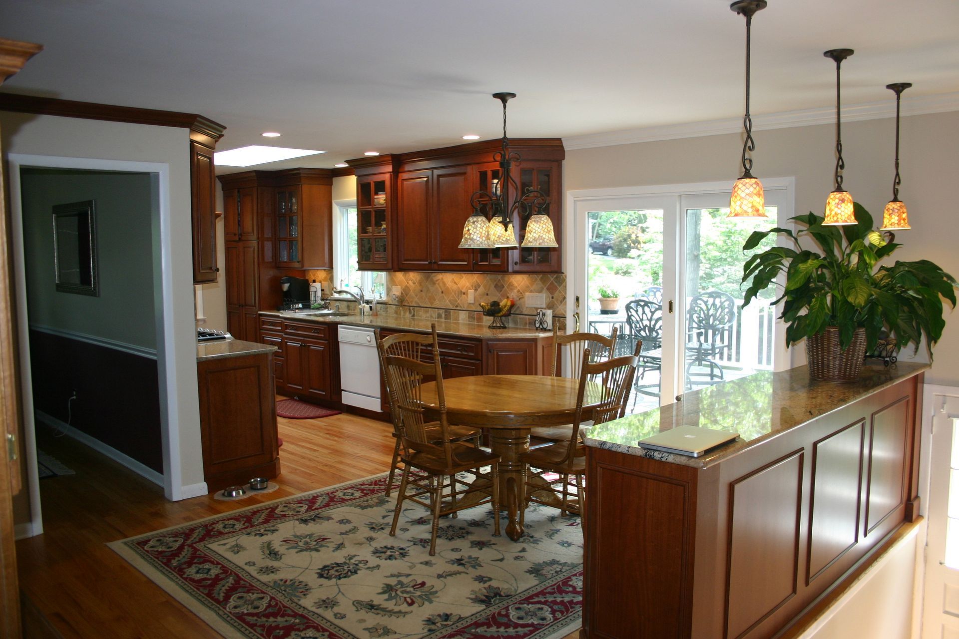 A kitchen with a table and chairs and sliding glass doors