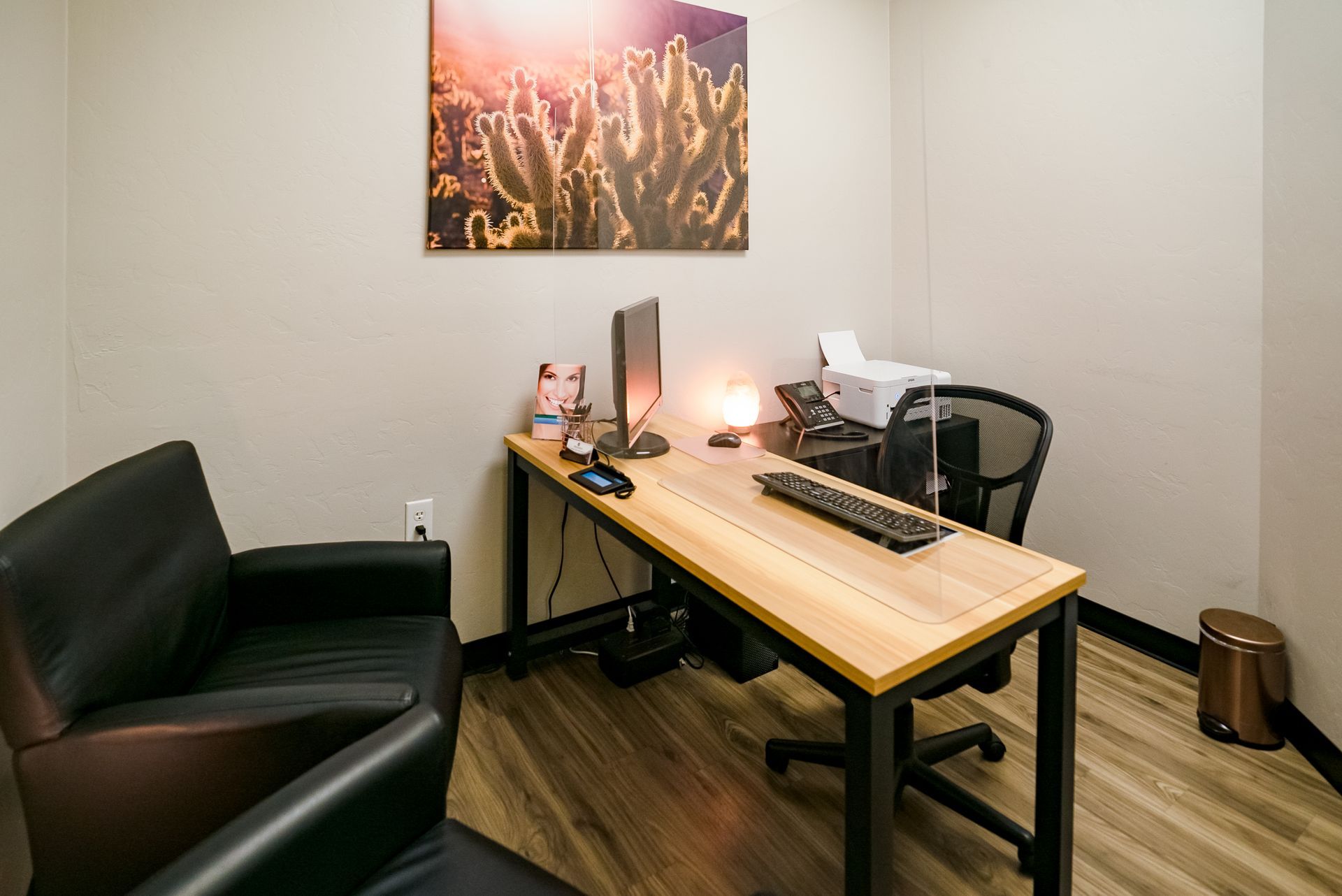 A waiting room with chairs and a television on the wall.