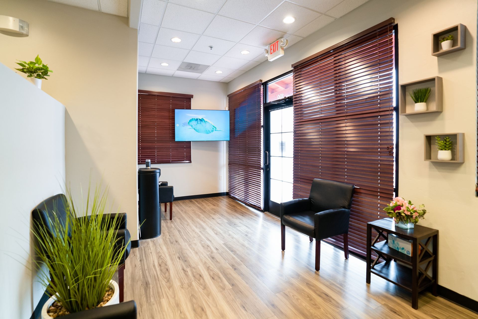 A waiting room with a lot of chairs and a counter.