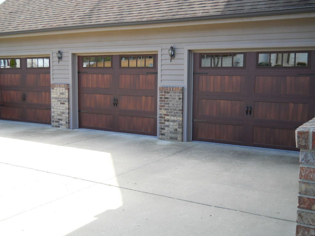 A row of wooden garage doors on a house