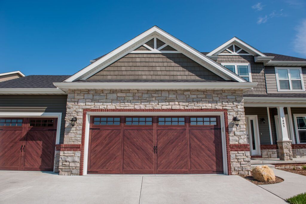 A large house with a large red garage door